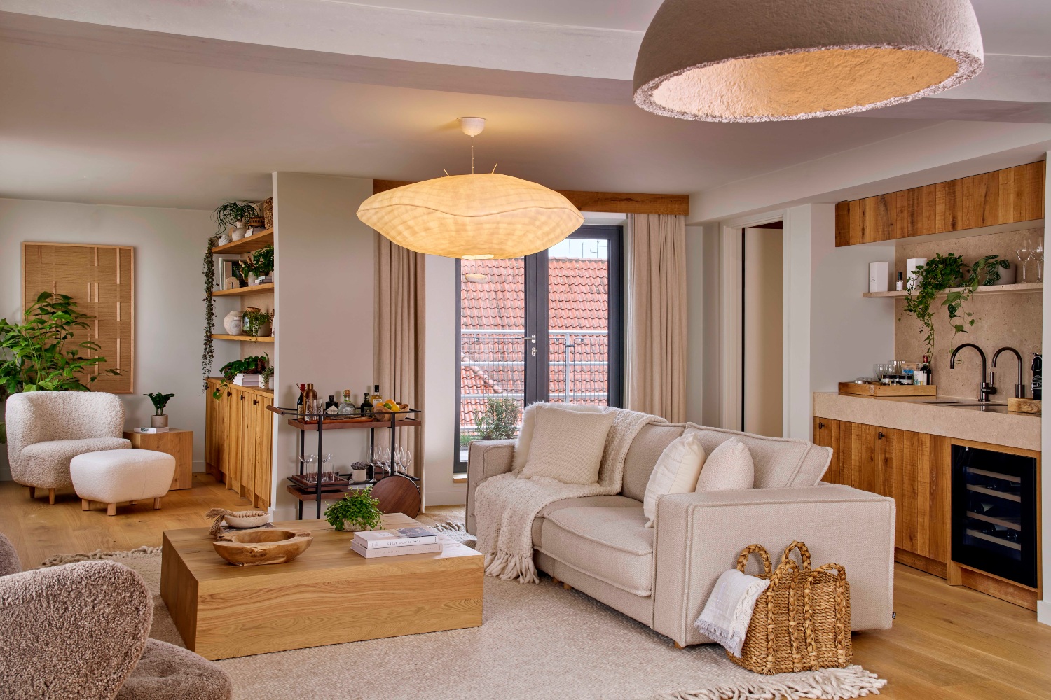 Spacious, eco-luxury living area featuring natural materials, stylish furniture, and large windows with a cozy atmosphere.