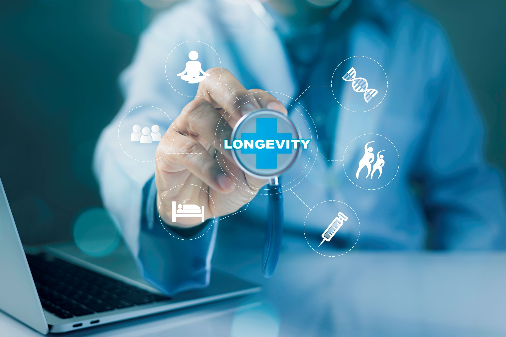 Hand reaching for a circular screen with the word "longevity," surrounded by health-related icons and a laptop in the background.