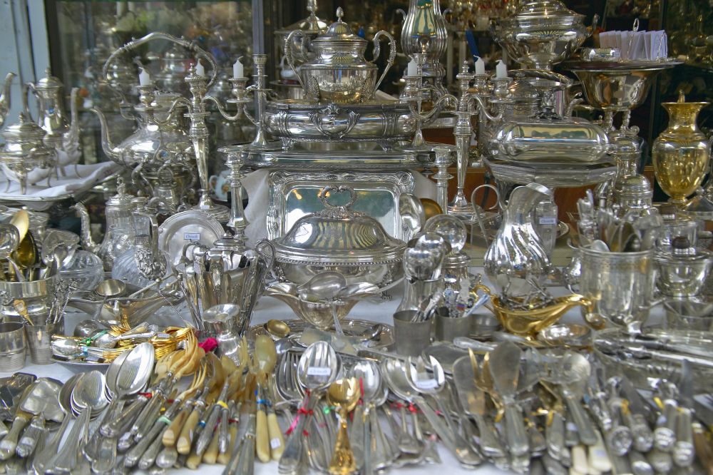Detailed display of various silver and gold decorative items and utensils, showcasing luxury craftsmanship and history.