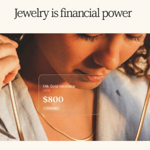 A woman examines a 14k gold necklace, showcasing its value and potential as a source of working capital.