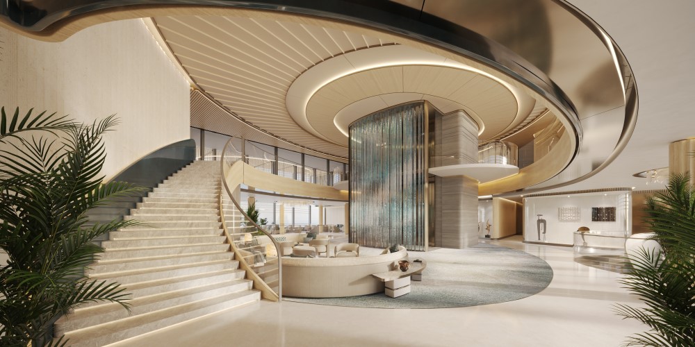 Main lobby of ULYSSIA featuring a modern staircase, elegant furnishings, and vibrant greenery, showcasing an inviting atmosphere.
