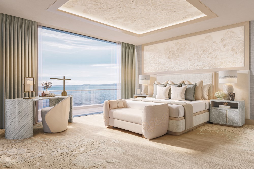 Bright, modern master bedroom featuring a large window with ocean views, elegant furnishings, and a stylish desk area.