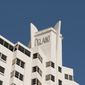 Delano Miami Beach hotel exterior showcasing its iconic architecture against a clear blue sky.