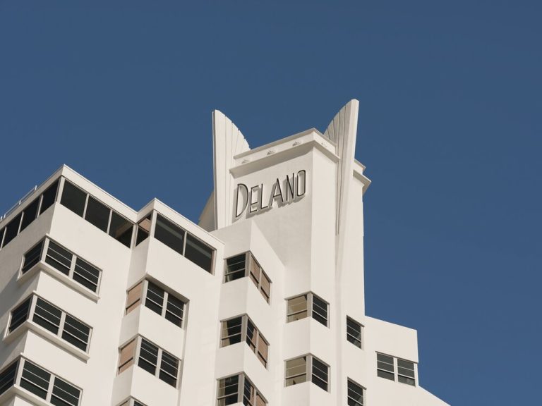 Delano Miami Beach hotel exterior showcasing its iconic architecture against a clear blue sky.