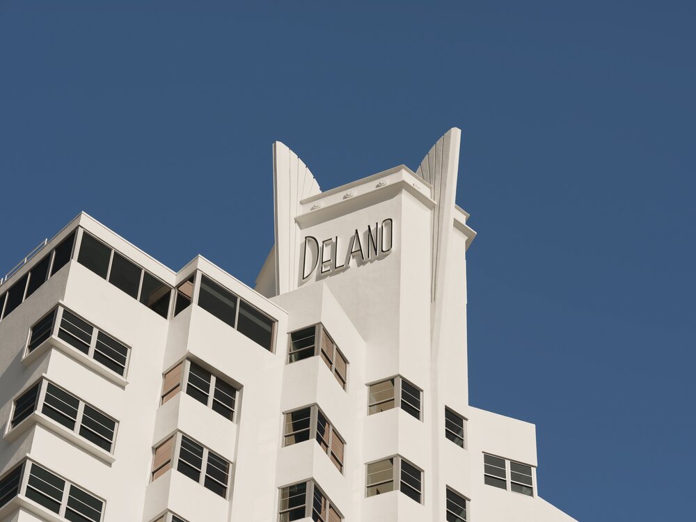 Delano Miami Beach hotel exterior showcasing its iconic architecture against a clear blue sky.