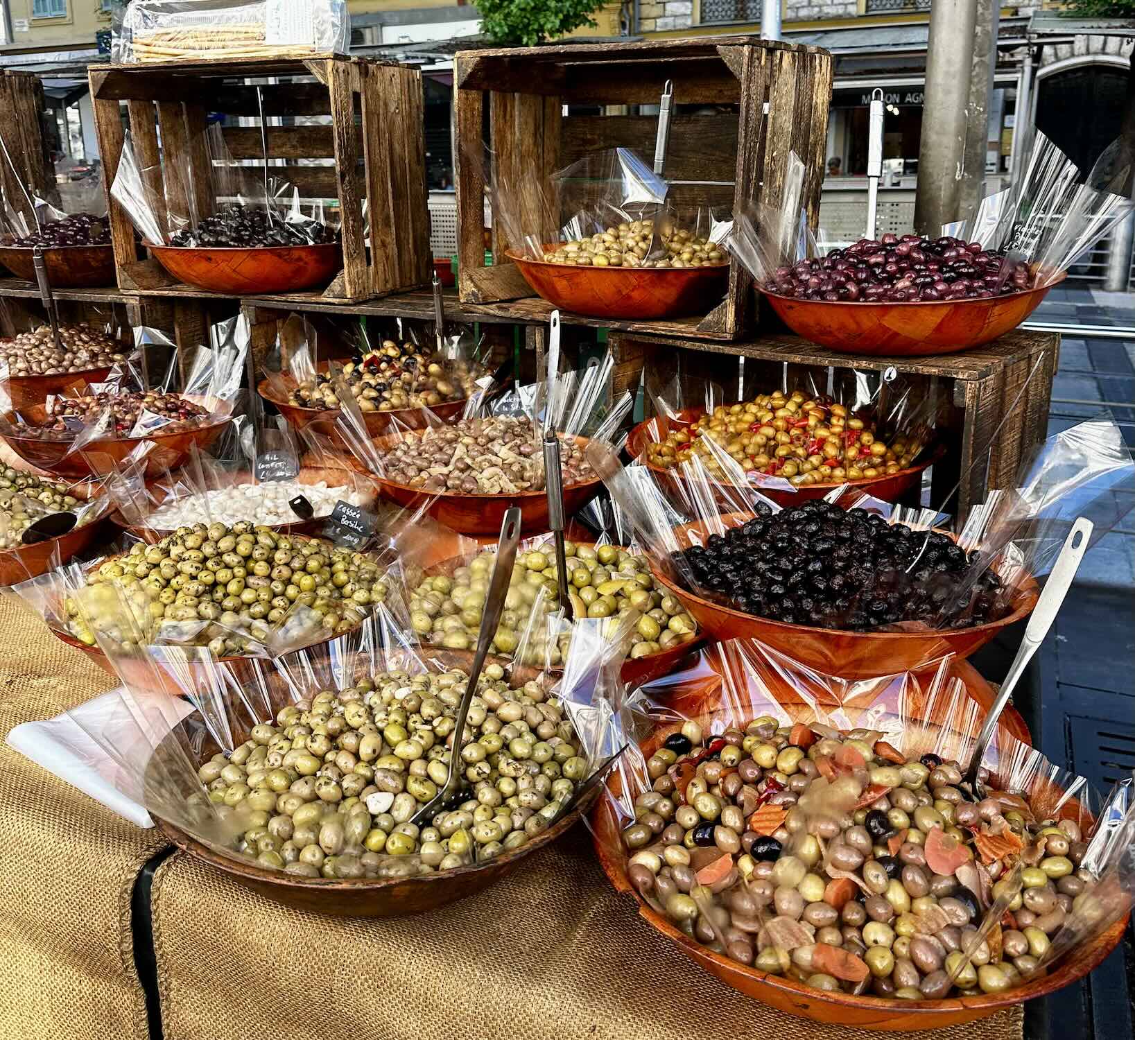 Variety of olives displayed in bowls at Marché de la Libération, showcasing local flavors and vibrant colors.