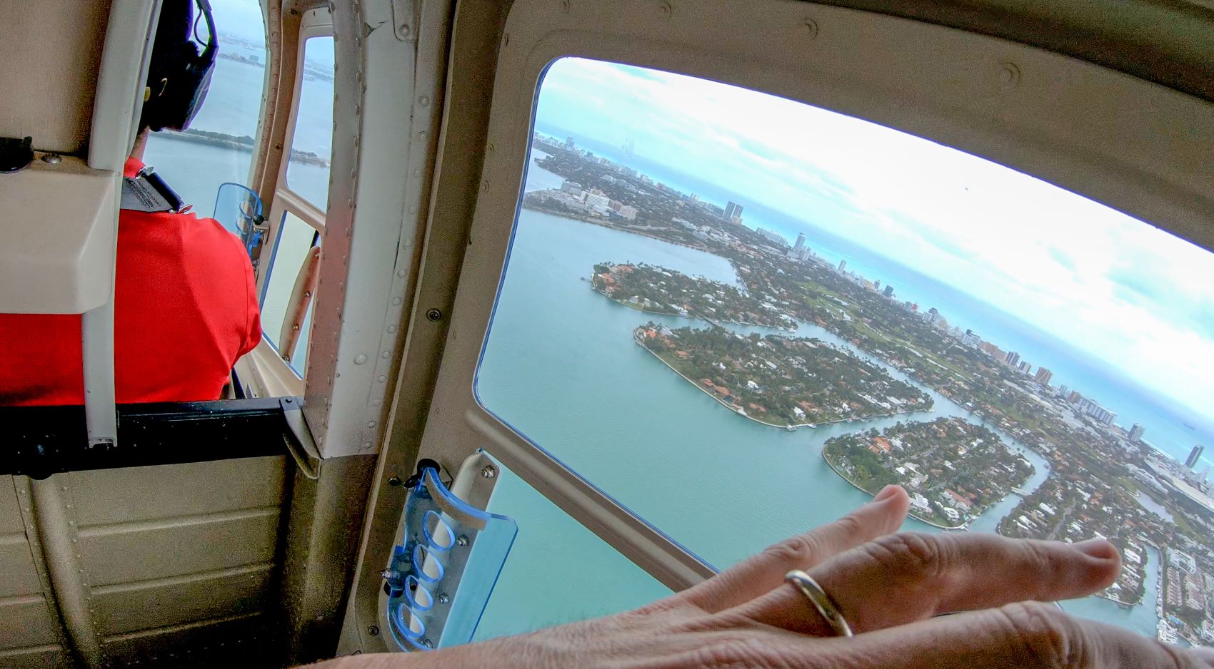 View from a helicopter showcasing Miami's coast, waterways, and urban landscape during a private discovery flight.