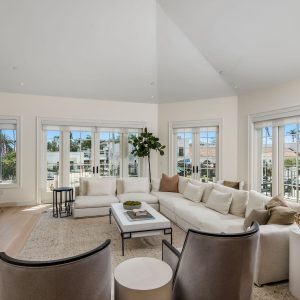 Bright and airy living room with a sectional sofa, modern furniture, and large windows overlooking Pacific Palisades.