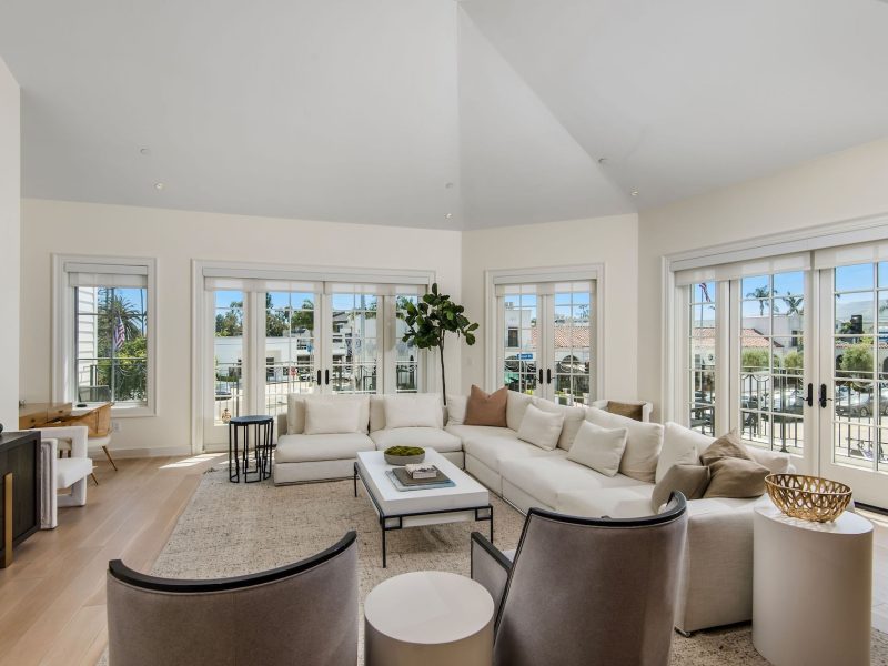 Bright and airy living room with a sectional sofa, modern furniture, and large windows overlooking Pacific Palisades.