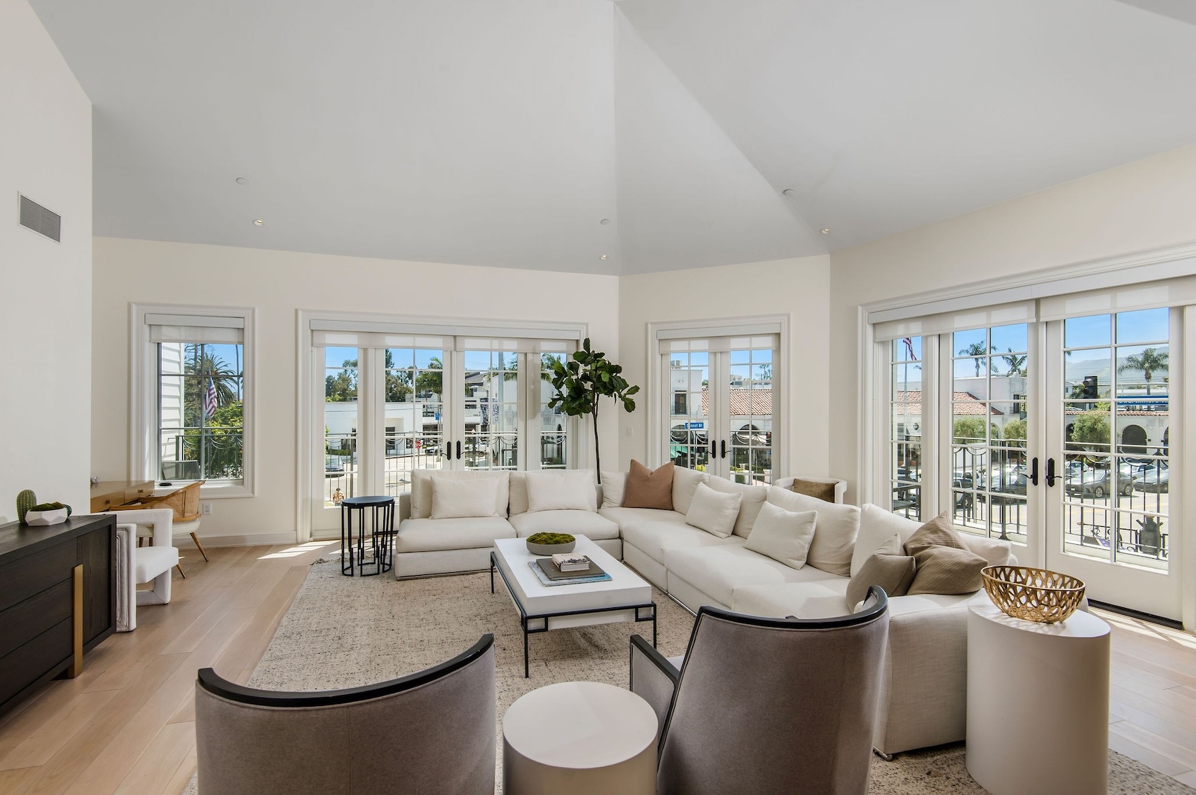 Bright and airy living room with a sectional sofa, modern furniture, and large windows overlooking Pacific Palisades.