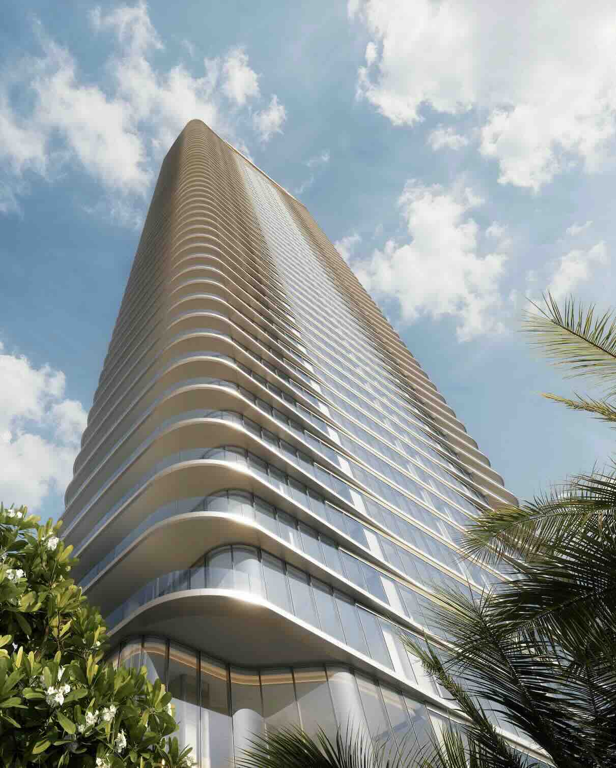 LILLI building, showcasing a modern design, rises against a blue sky with palm trees in the foreground, symbolizing luxury living.