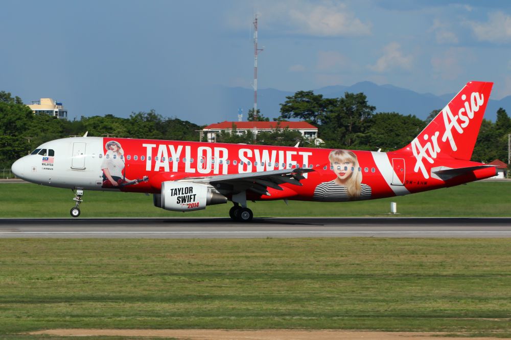 AirAsia airplane featuring a vibrant Taylor Swift design with her image and name prominently displayed on the fuselage.