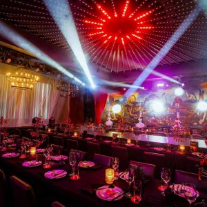Luxuriously decorated dining area with ambient lighting and theatrical elements, ready for an immersive dining experience.