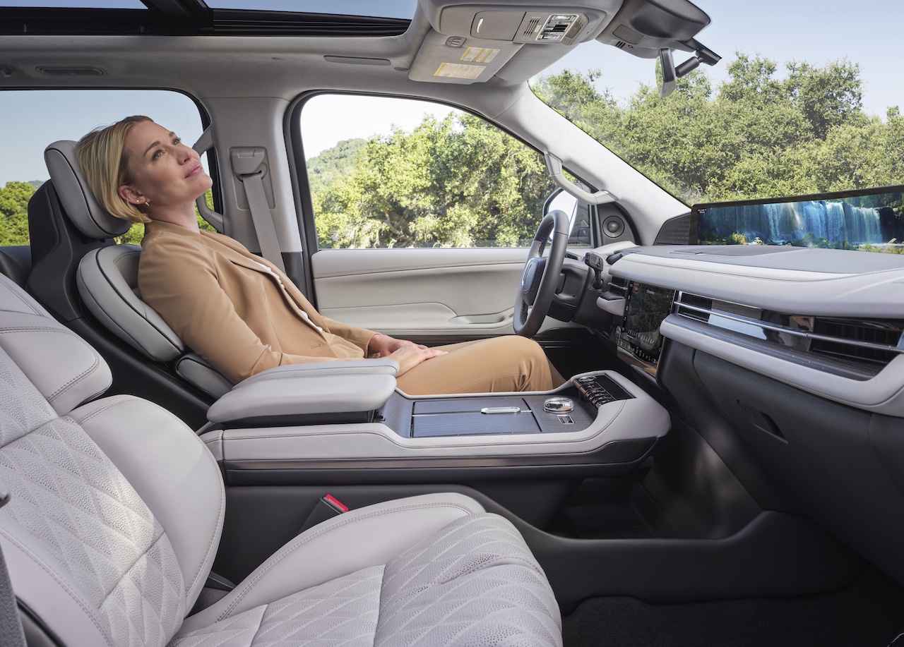 A woman relaxes in the luxurious interior of a 2026 Lincoln Navigator, showcasing comfort and modern design.