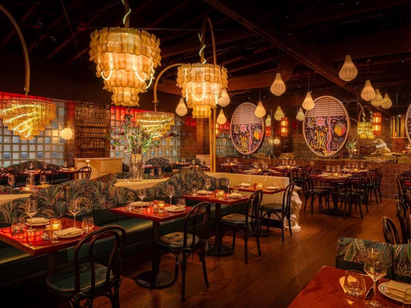 Elegant interior of Bad Roman, featuring vibrant decor, stylish furnishings, and unique chandeliers in a lively dining atmosphere.