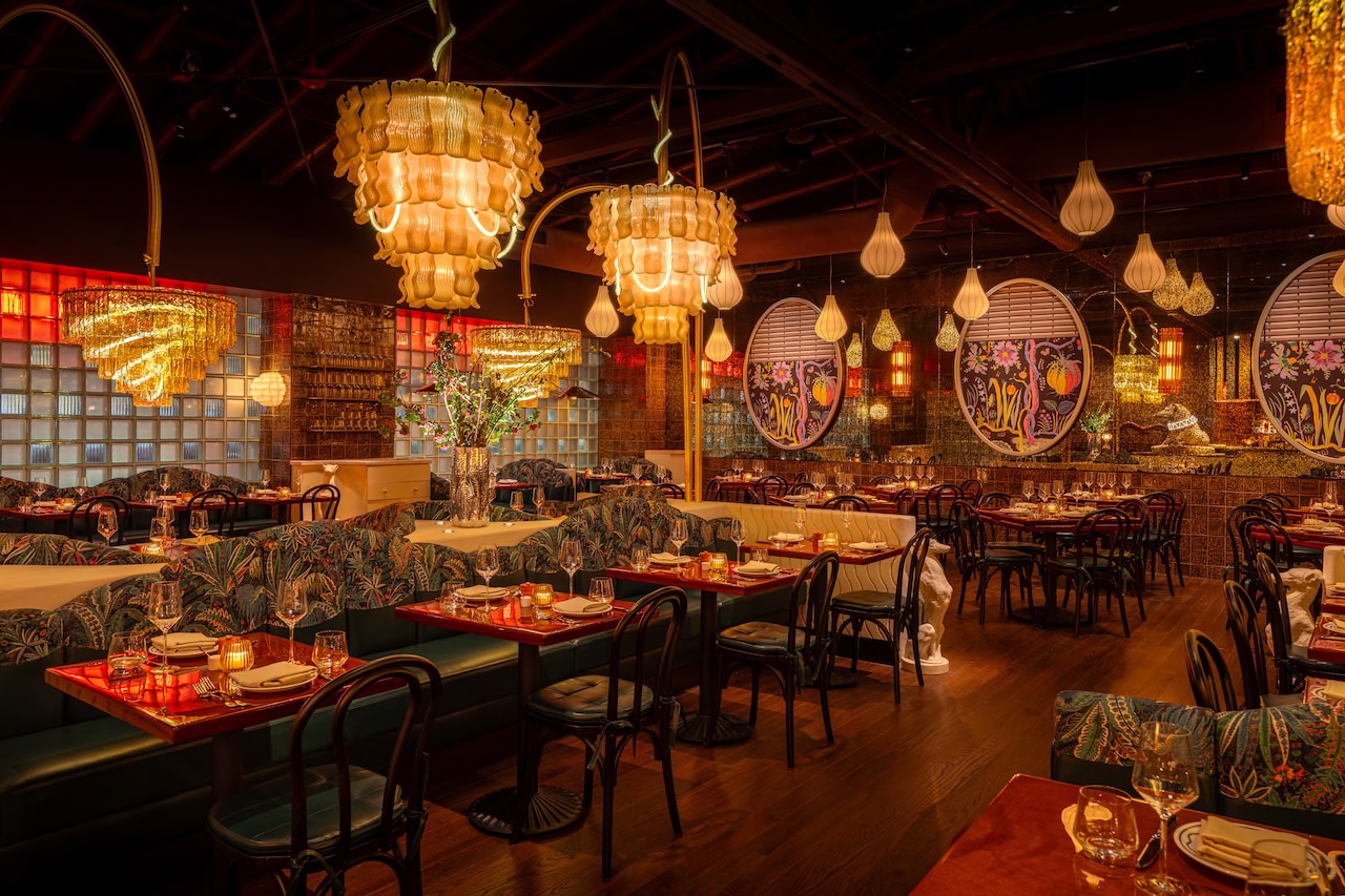 Elegant interior of Bad Roman, featuring vibrant decor, stylish furnishings, and unique chandeliers in a lively dining atmosphere.