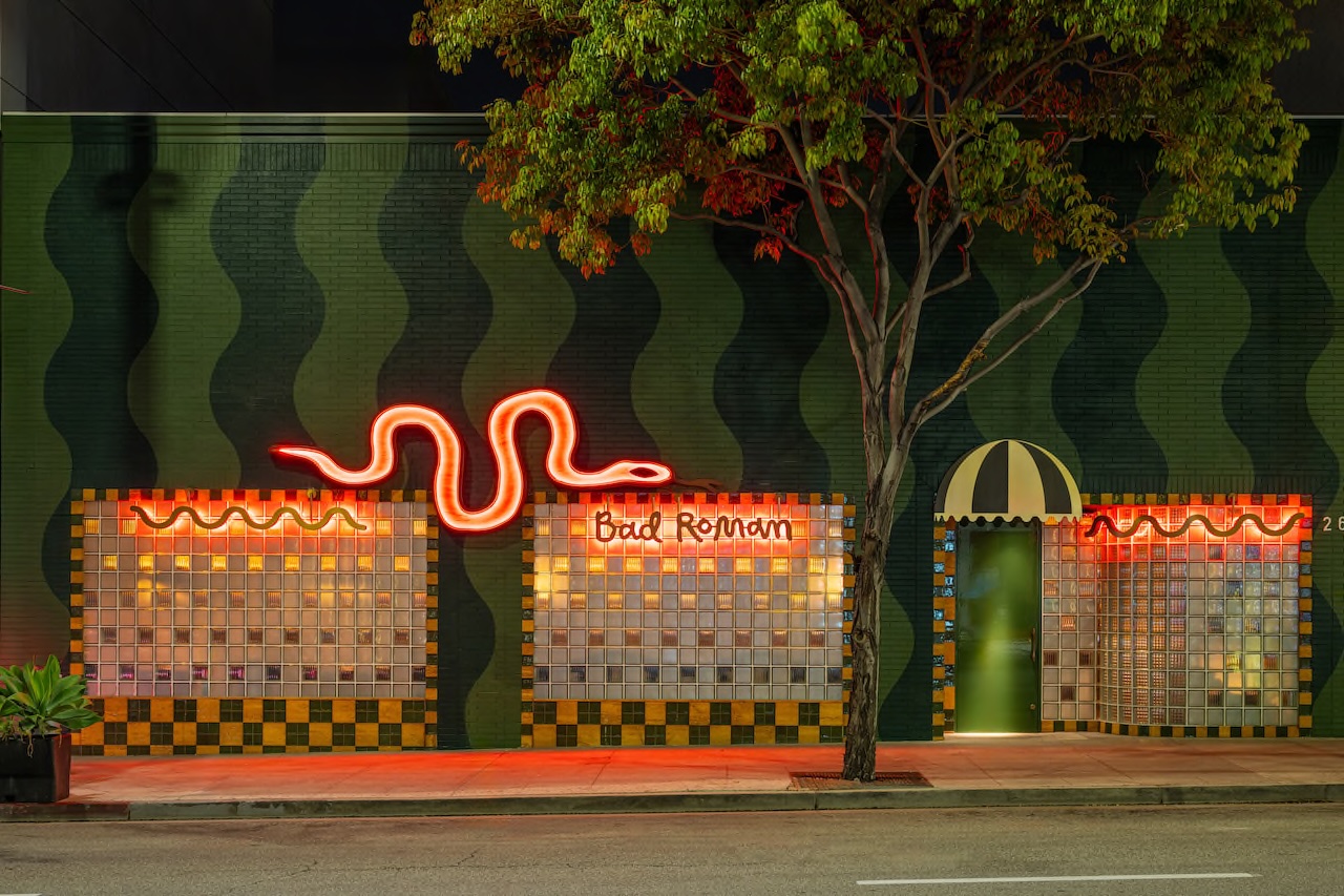 Vibrant exterior of Bad Roman restaurant in Beverly Hills featuring neon signage and a colorful facade.
