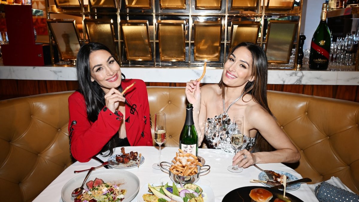 Twin sisters enjoying a luxurious dinner at Palms Las Vegas with an array of gourmet dishes and champagne.