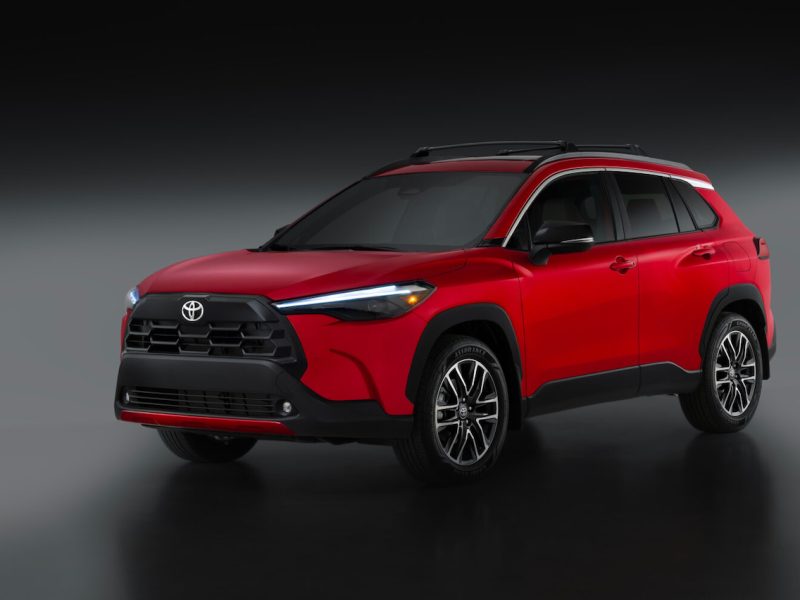 2026 Toyota Corolla Cross in red, showcasing a modern design and sporty features. Ideal compact SUV for urban driving.