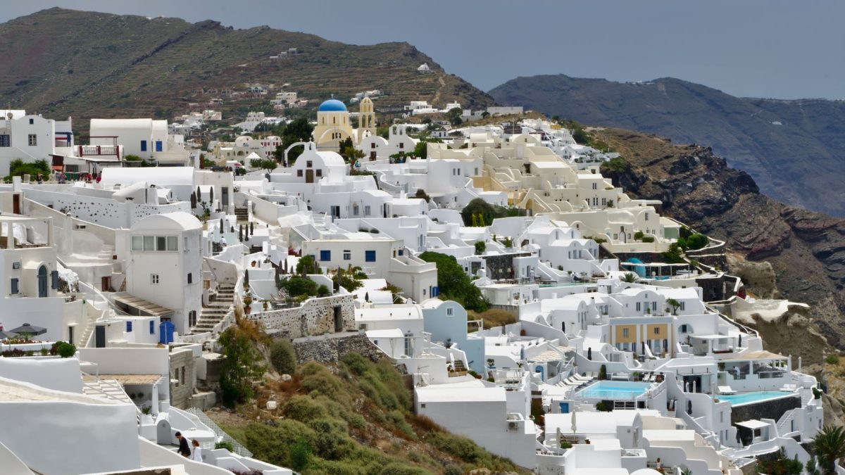 Whitewashed buildings with blue domes on a hillside, showcasing the charm of a lesser-known island destination.