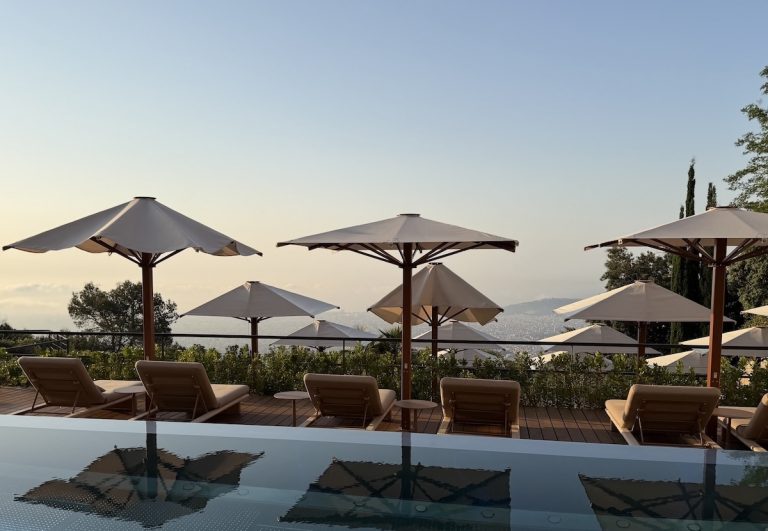 Luxurious sun loungers and umbrellas overlook the city, creating a serene escape at the METT Barcelona.