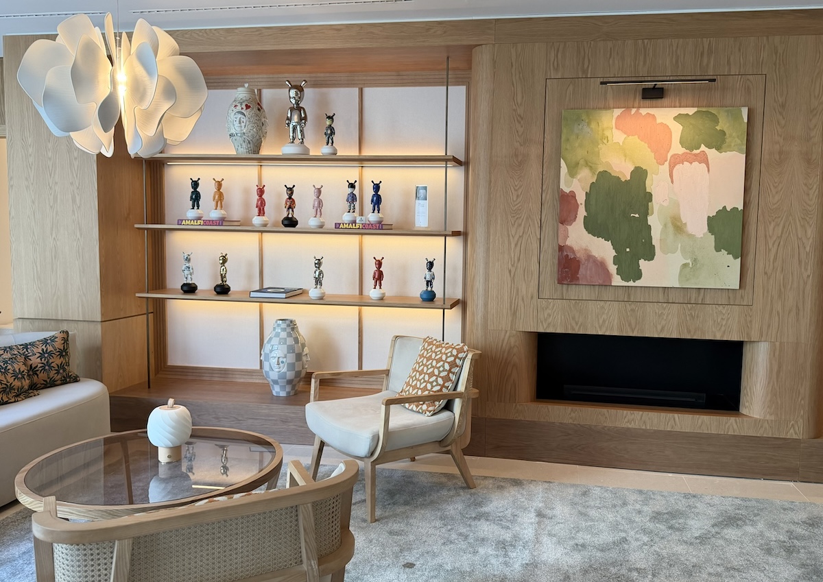 Stylish interior of the METT Barcelona featuring decorative shelves, modern art, and a cozy seating area.