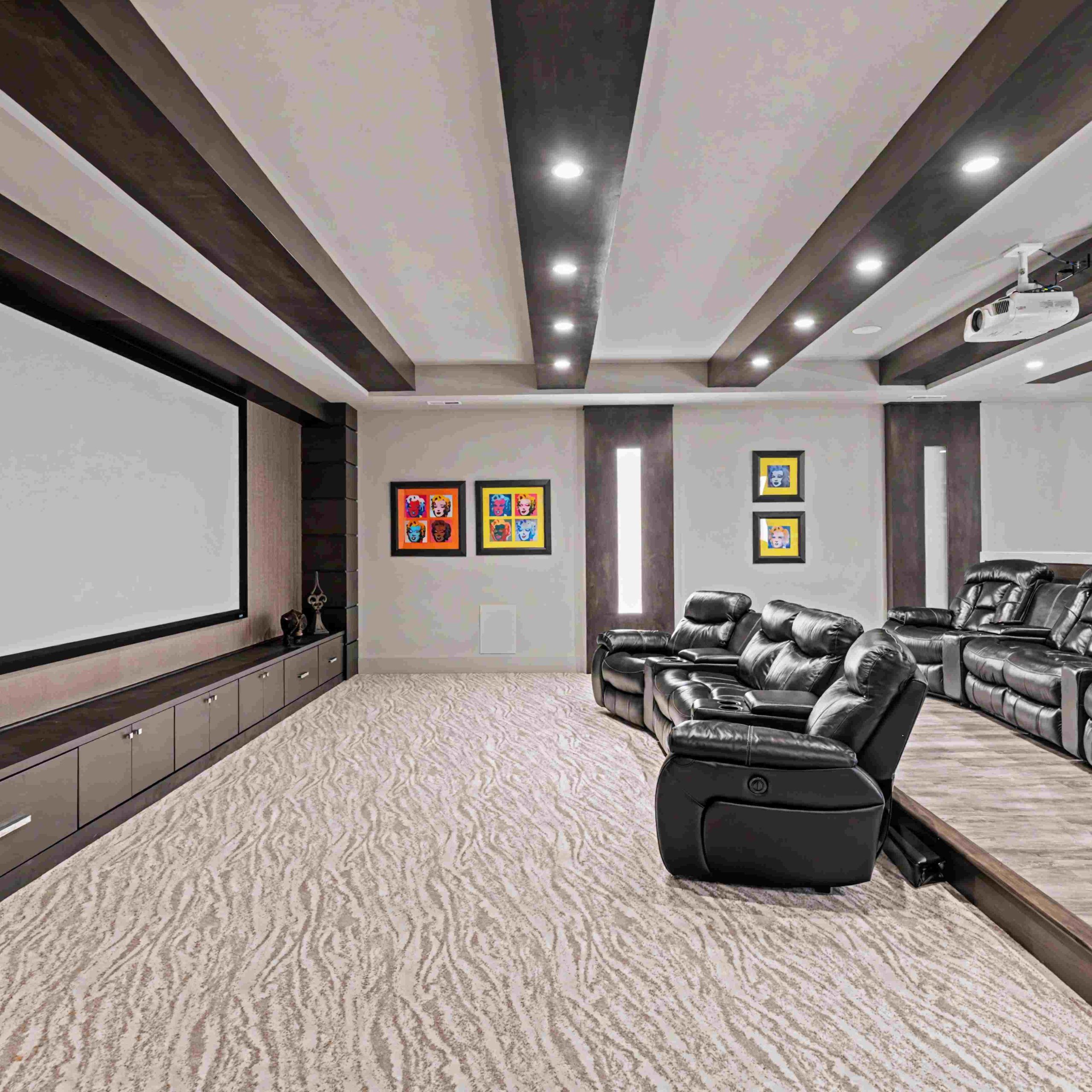 Luxurious home theater featuring reclining leather seating, a projector screen, and stylish decor in Hinckley.