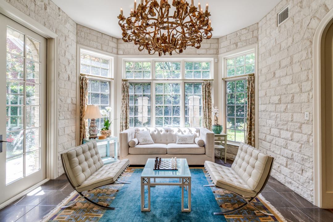 Bright and airy living room with large windows, elegant chandelier, modern furniture, and a cozy atmosphere in University Park.