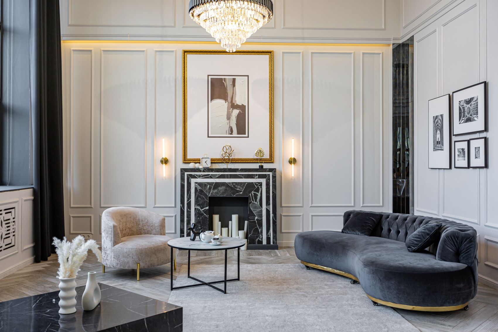 Luxurious living room featuring elegant furniture, a marble fireplace, and art decor against refined wall paneling.
