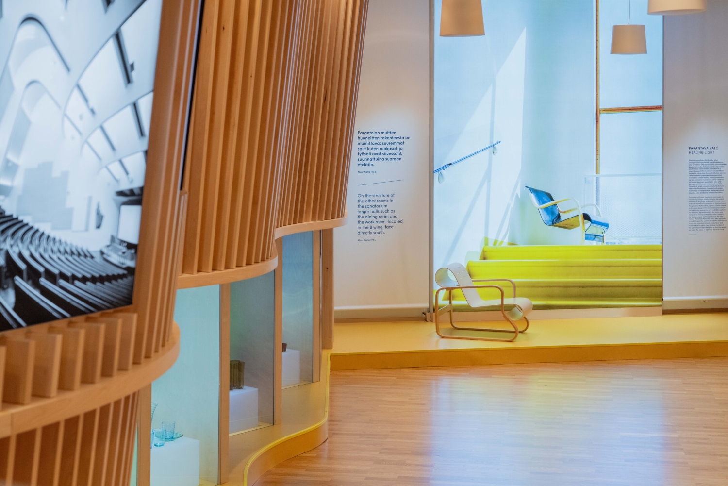 Interior view showcasing modern design elements, including wooden structures and colorful seating areas in a Helsinki space.