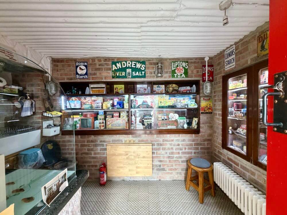 Historic artifacts and vintage advertisements displayed in a cozy corner of a luxury Irish guesthouse.
