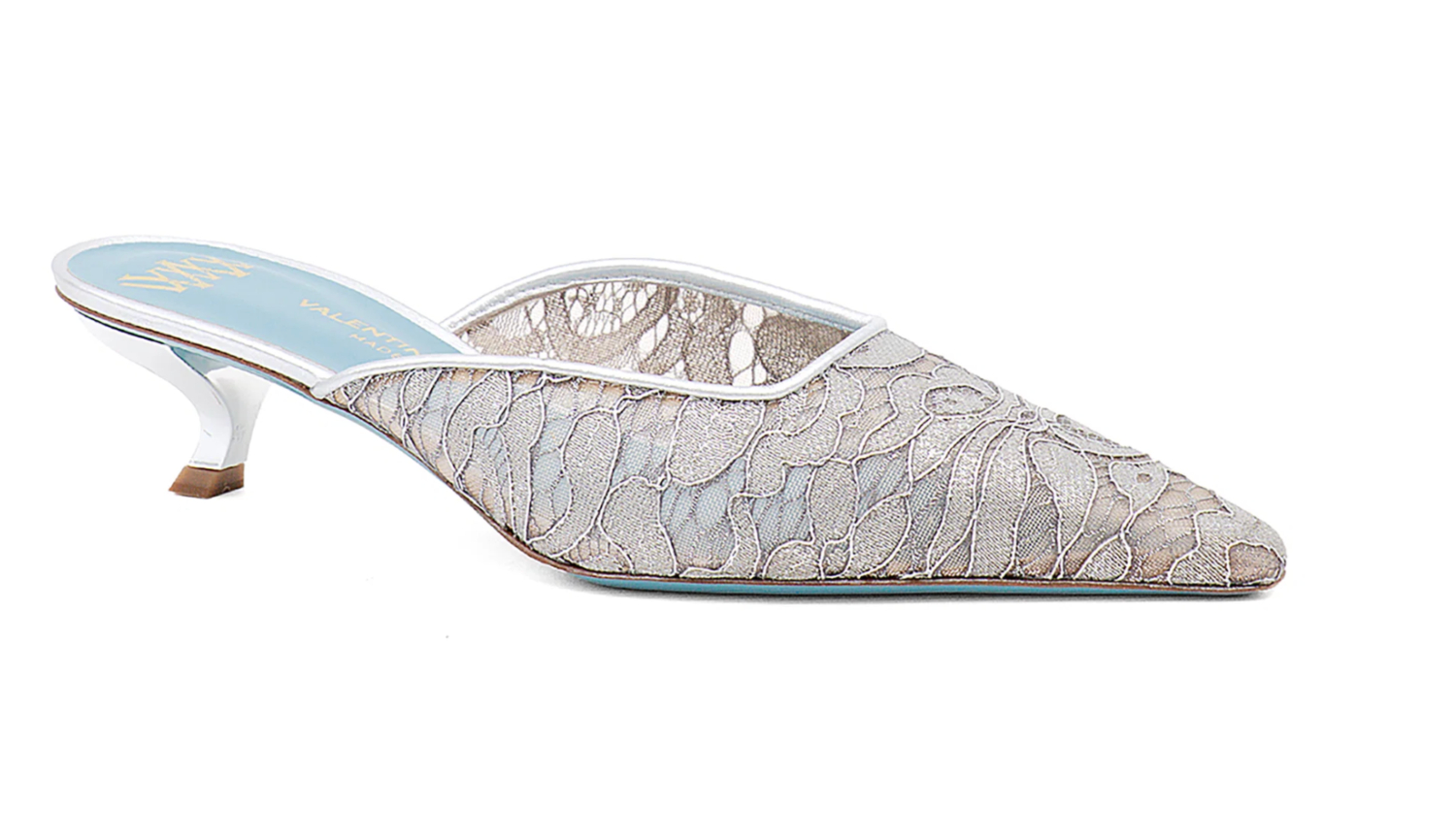 Silver lace mules with a pointed toe and a modest heel, designed for an elegant and elevated style.