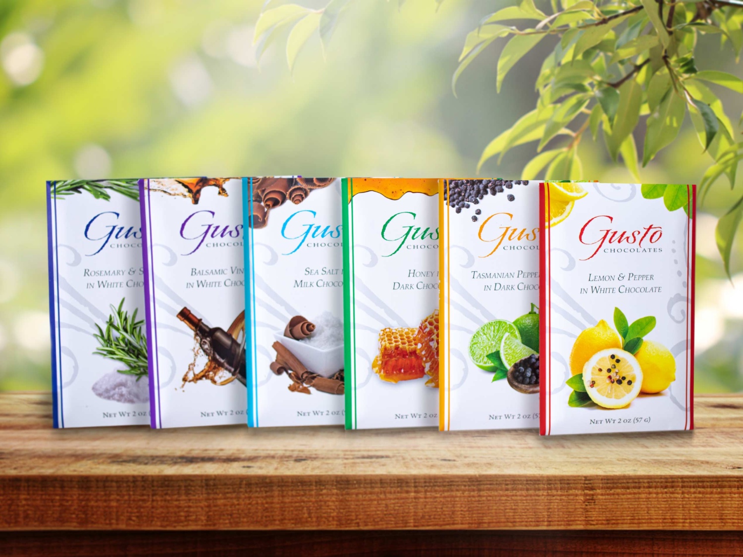 Gusto Chocolates packaging featuring unique flavors like rosemary, balsamic vinegar, sea salt milk chocolate, and lemon pepper.