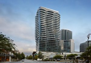 Modern luxury hotel building in Bellevue, showcasing sleek design and glass architecture against a cloudy sky.