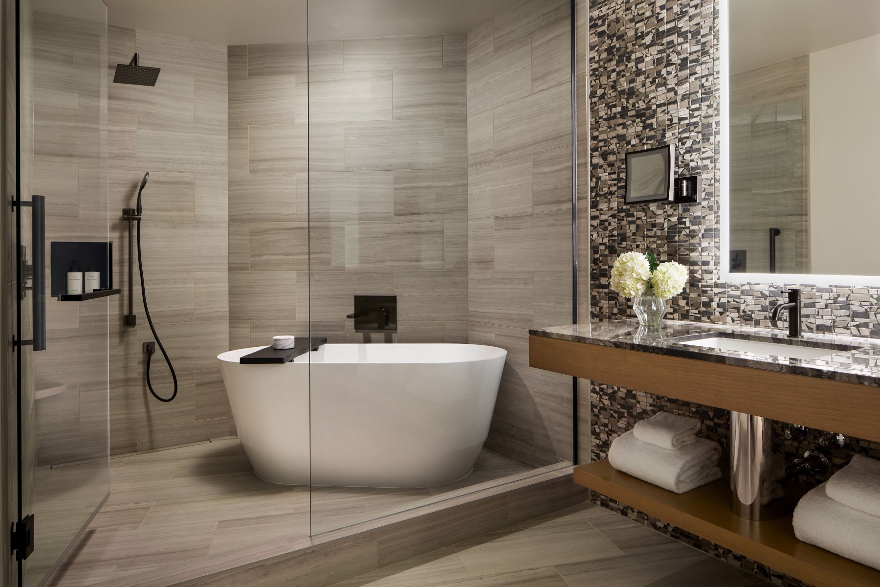 Contemporary bathroom featuring a freestanding bathtub, modern fixtures, and elegant tile work.