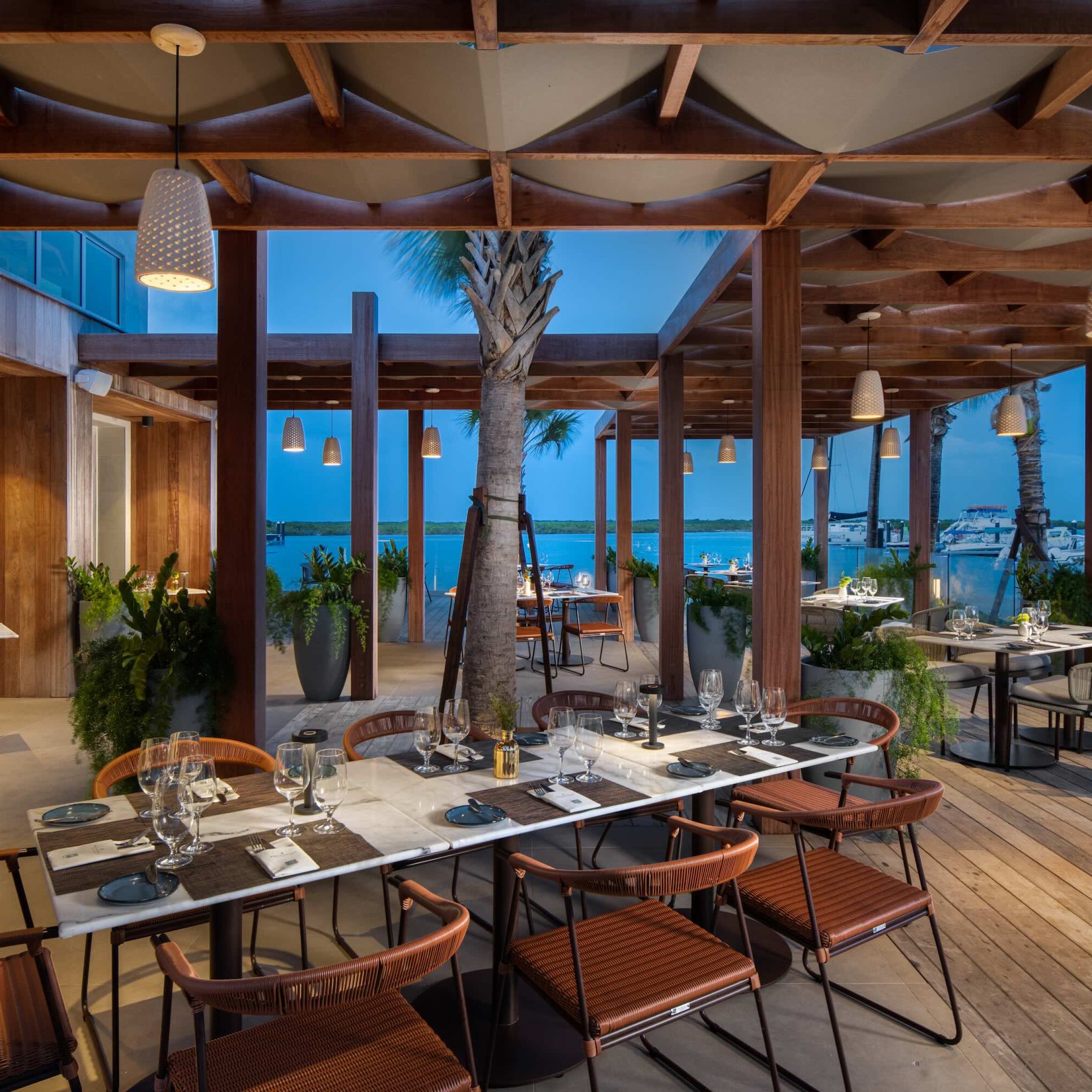Stylish dockside dining setup at Anchorage Restaurant with views of the water and elegant table arrangements.