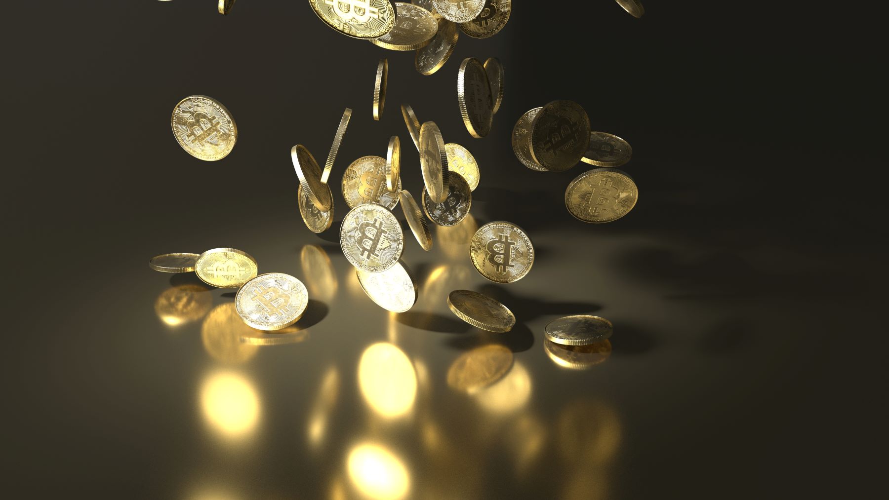Falling Bitcoin coins shine against a dark background, symbolizing the future of cryptocurrencies and investment potential.