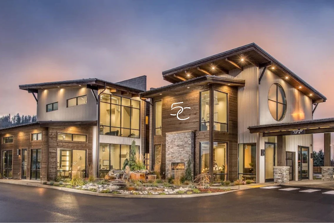 Modern clinic exterior featuring large windows, wood accents, and landscaped surroundings at CDA National Reserve.