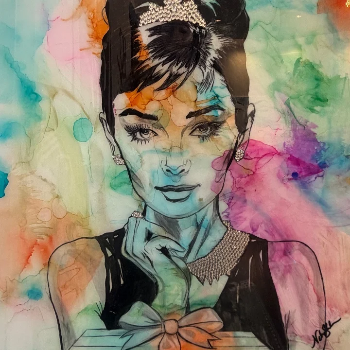 Colorful portrait of a sophisticated woman with a bow, exuding elegance against a vibrant, abstract background.