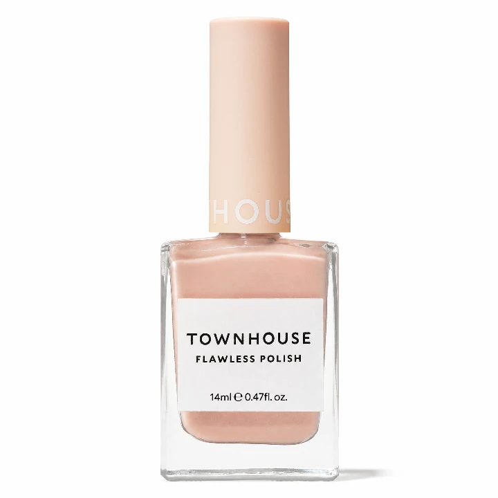Light pink nail polish in a glass bottle labeled Townhouse Flawless Polish, perfect for autumn nail trends.