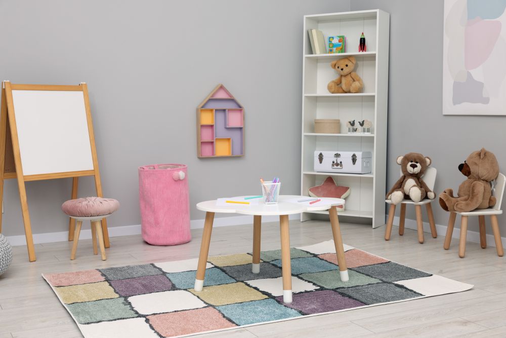 Colorful playmat in a playroom with a small table, chairs, a shelf of toys, and a cozy atmosphere ideal for children.