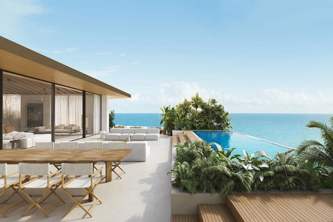 Modern terrace overlooking the ocean, featuring an infinity pool, stylish outdoor seating, and lush tropical landscaping.