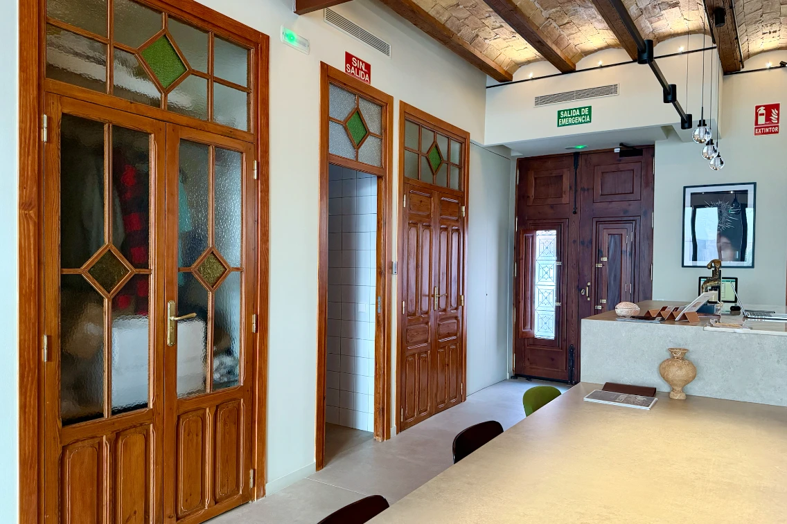 Interior view of La Novieta hotel showcasing wooden doors, a reception area, and a stylish, modern design.