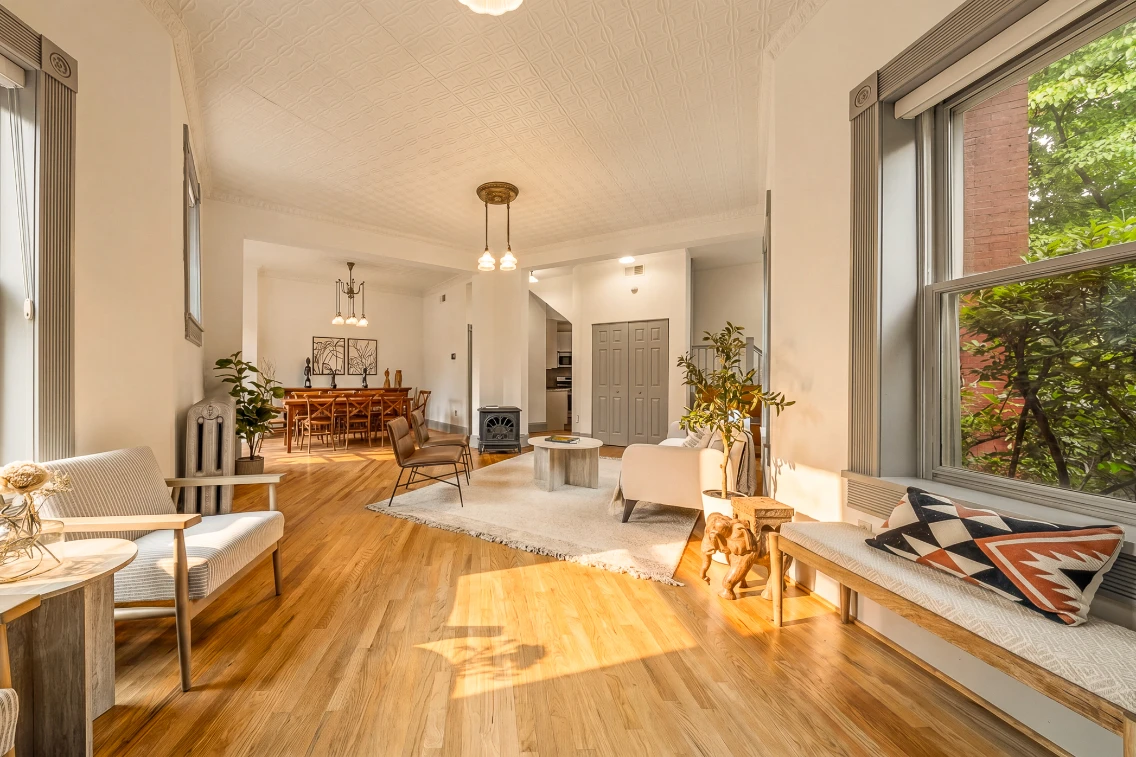 Bright and airy interior of a Victorian home featuring wooden floors, stylish seating, and contemporary decor in Capitol Hill.