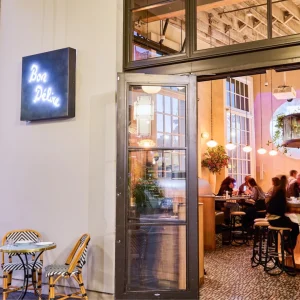 Bon Délire restaurant entrance on San Francisco’s Embarcadero, featuring outdoor seating and lively indoor dining atmosphere.