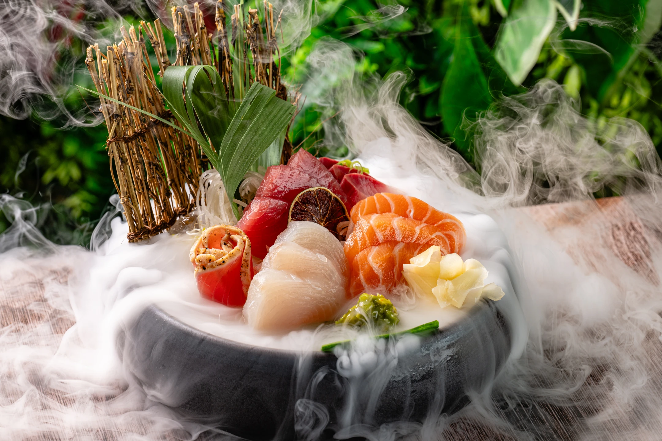 Sashimi platter presented with vibrant seafood and garnishes, surrounded by wisps of smoke on a rustic wooden table.