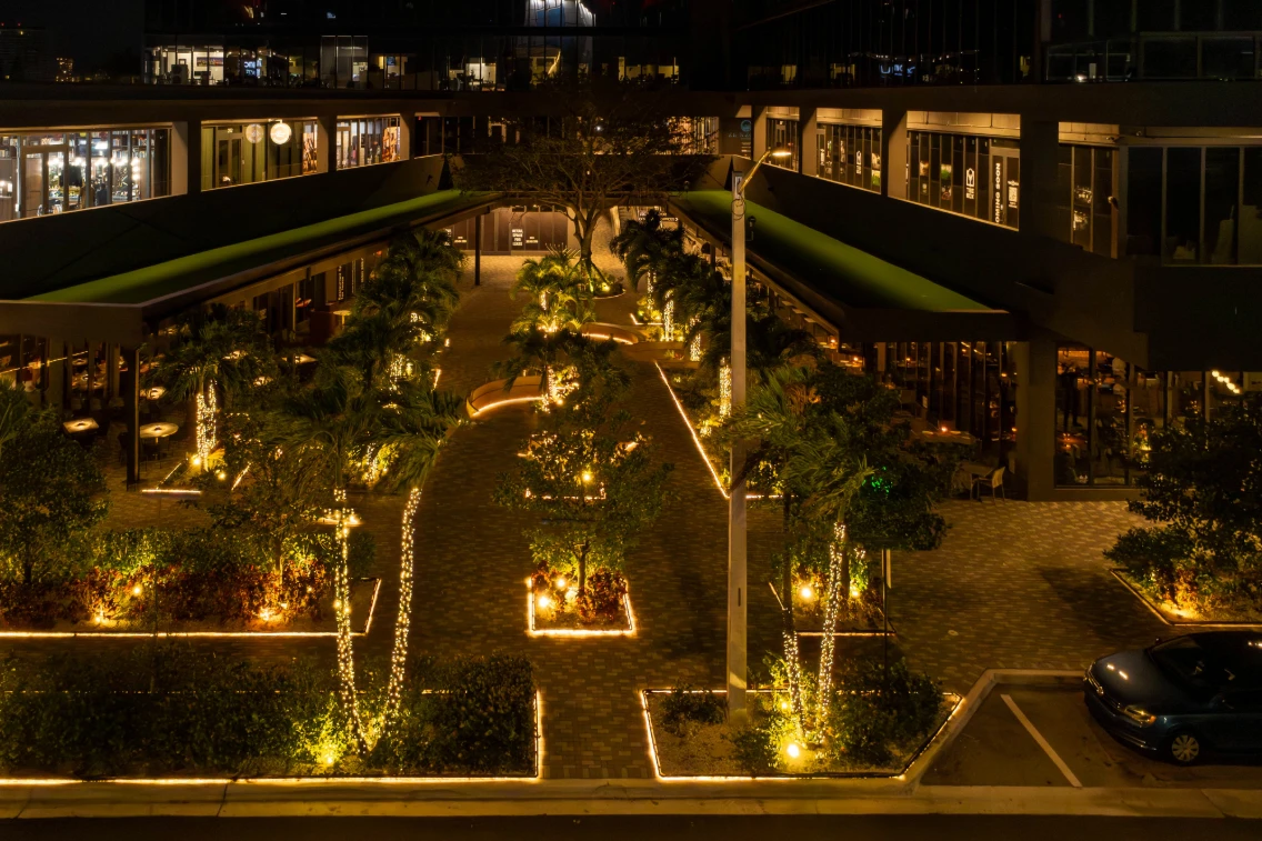 Outdoor view of Gioia Italy Restaurant featuring lush landscaping and warm lighting, blending Italian heritage with modern design.