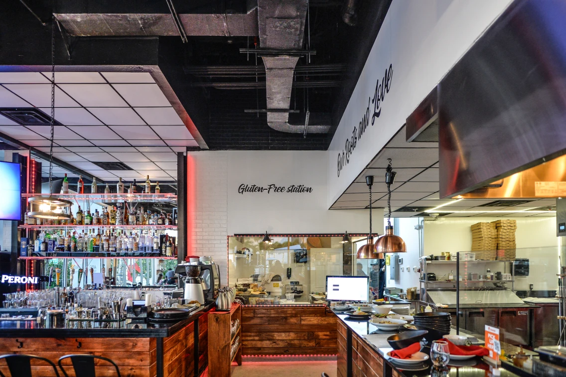 Modern Italian restaurant interior featuring a bar, gluten-free station, and a mix of traditional and contemporary decor.