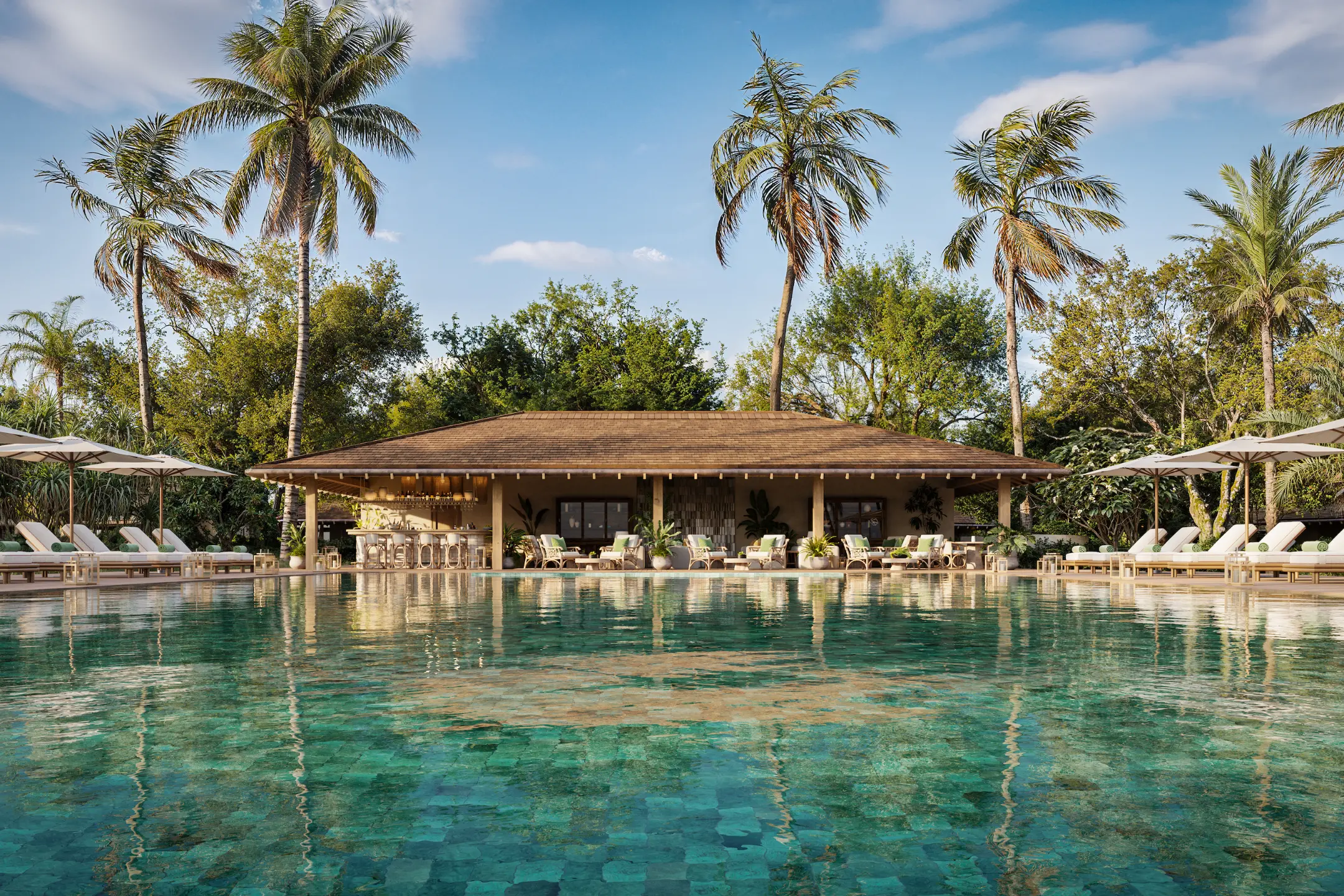 Luxurious pool area at a Nobu resort, featuring palm trees, lounge chairs, and a bar, set against a clear blue sky.