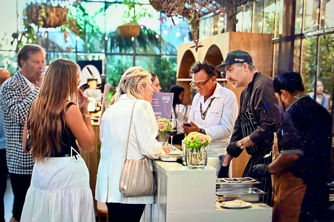 Guests engaging with chefs at a culinary event showcasing local flavors at the James Beard Foundation's Taste America.